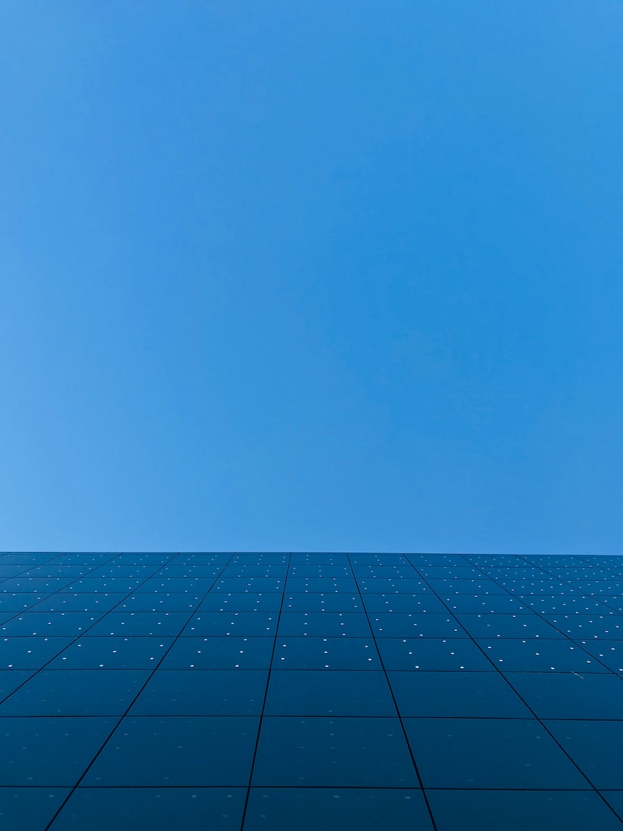 blue sky over black and white concrete building